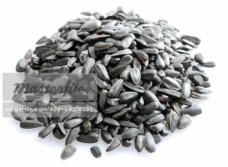 Small pile of sunflower seeds isolated on white background.