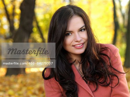 Beautiful woman spending time in park during autumn season