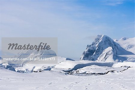 Mountain range is covered with white snow in Antarctica