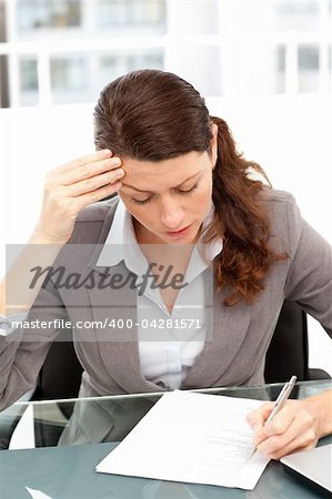 Worried businesswoman working at a table in her office