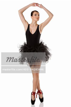 classic dancer with black dress and shoes on white background dancing on pointe