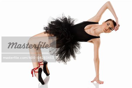 classic dancer with black dress and shoes on white background stretching her body