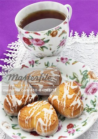 Cup with the black tea and the  cookies