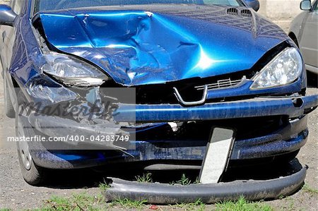 Small blue car smashed at frontal collision