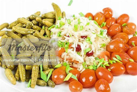 Marinated vegetables closeup at the plate isolated on a white background