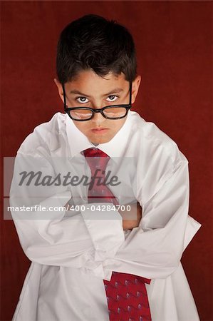 Cute young boy in his father's shirt and eyeglasses