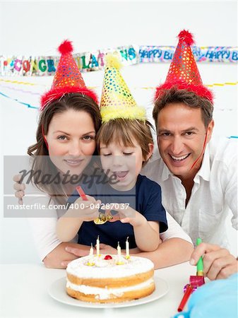 Little boy celebrating his birthday at home with his parents