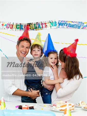 Portrait of parents with their children during a birthday party at home
