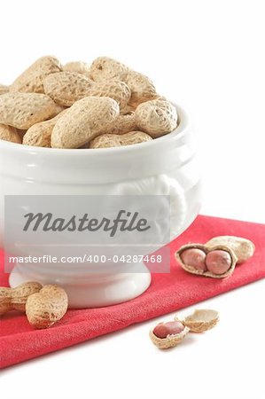 Peanut in a white ceramic bowl on a red linen napkin