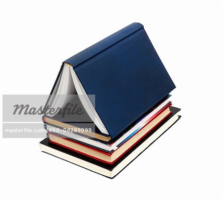 House made with books piled on white background