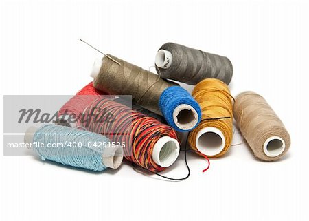 Group colored skeins of thread on white background