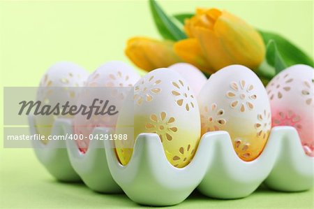 Flowery Easter eggs in an egg holder. Shallow dof