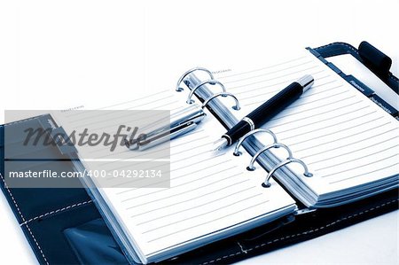 empty business notebook or organizer with pen