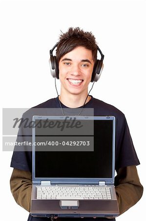 Male Teenager with earphones makes Internet mp3 music download at computer. Isolated on white background.