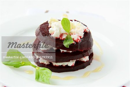 appetizer salad of beets and goat cheese with basil and olive oil