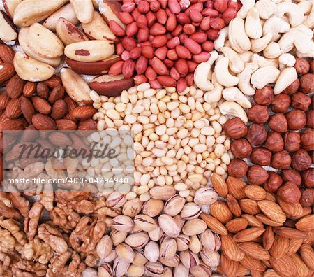 Assorted pine nuts, filbert, peanut, pistachios, walnut, almonds and  hazelnuts on natural sackcloth can use as background