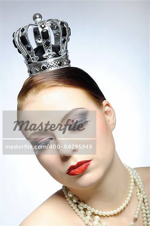 elegant queen female face with red shiny lips and black eye makeup. colse-up.