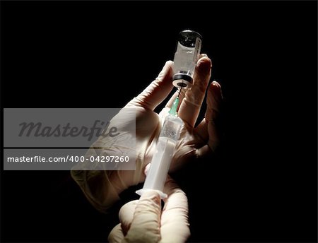 hypodermic syringe that is being filled with vaccine in clinic