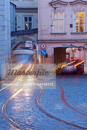 prague - cars and tramways passing under buildings at mala strana