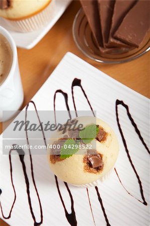 Delicious chocolate muffin on a decorated plate