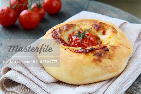 Italian Focaccia bread with tomato and cheese on the board