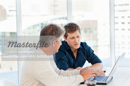 Two businessman working on their laptop in a office