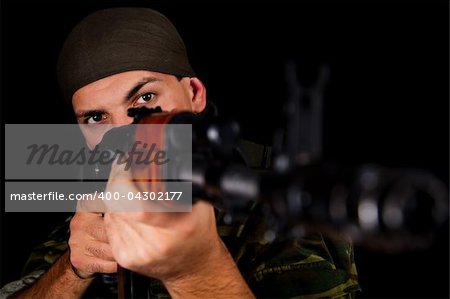 Soldier in uniform with rifle, selective focus on face