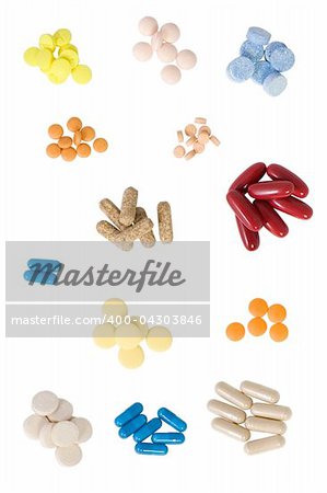 different shape and colors pills on white background