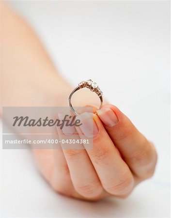 an image of engagement ring held in hand