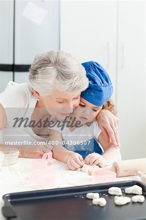 A little girl baking with her grandmother at home