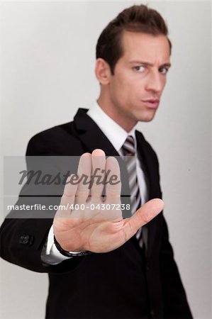 Business Man Making Stop Sign - focus on hand