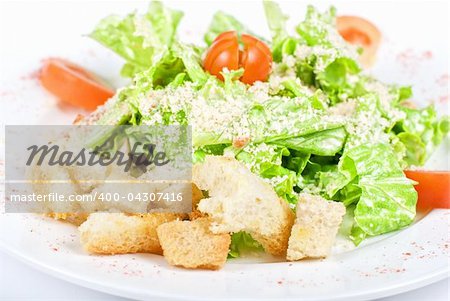 salad of meat, vegetable and dried crust dish close up on a white background