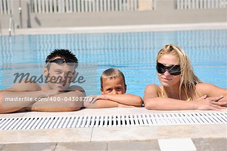 happy young family have fun on swimming pool  at summer vacation