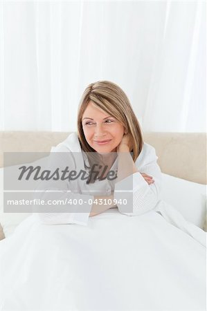 Portrait of a pretty woman on her bed at home