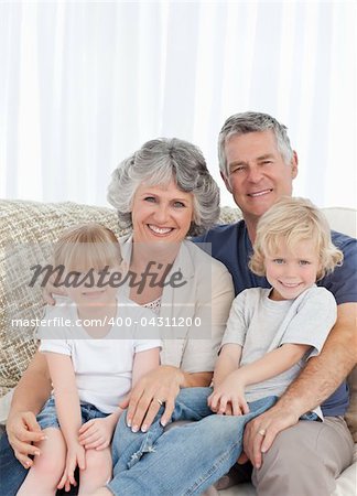 Joyful family looking at the camera at home