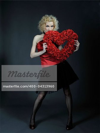 Pretty seductive woman with red heart