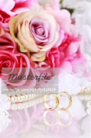 Wedding still life with beautiful golden rings and bouquet