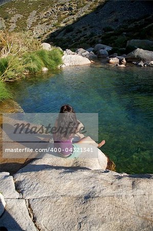 woman on a river at Gredos mountains in Avila Spain