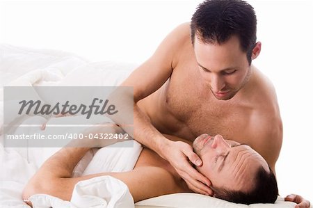 Happy homo couple in a white bed taking care of his boyfriend