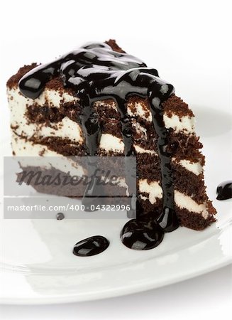 Piece of cake with black chocolate syrup