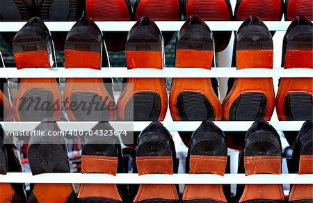 Lots of men's shoes on display at a market