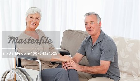 Man with his wife in a wheelchair