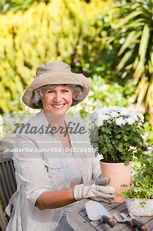 Senior woman with flowers in her garden