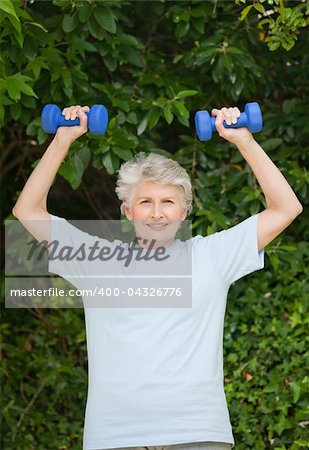 Mature woman doing her exercises in the garden