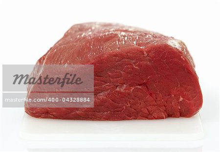 fresh raw meat on white cutting board