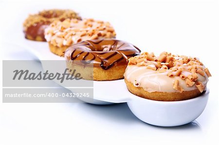 Colorful and tasty donuts on white background