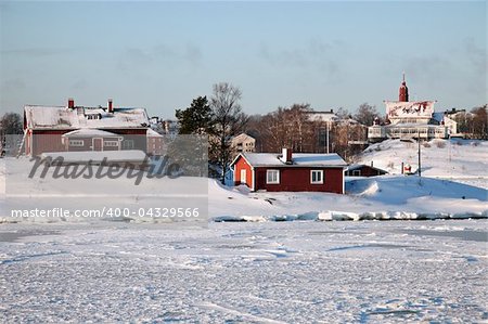 Red Helsinki buildings seen from frozen Baltic Sea.