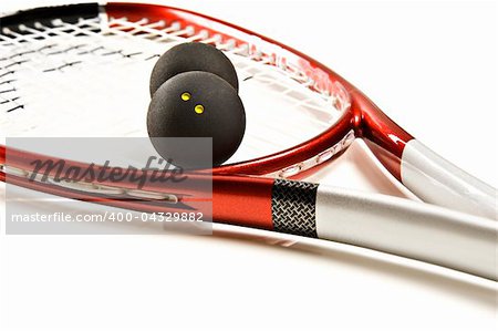 Close up of a red and silver squash racket and ball
