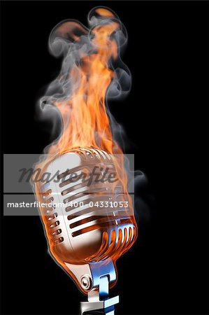 old mic in flames. isolated on black.