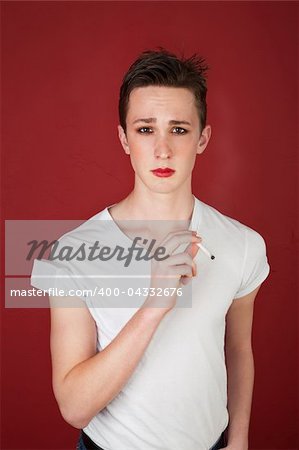 Caucasian tough teen in t-shirt smoking a cigarette